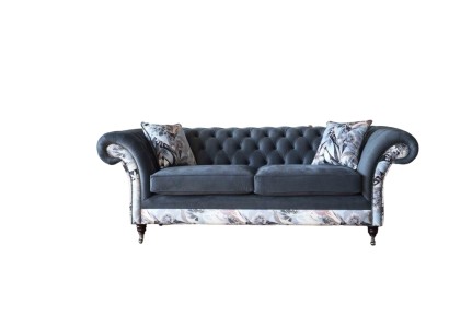 Ein auffälliges Dreisitzer-Sofa im Chesterfield-Design mit zarter grauer Blumendekoration